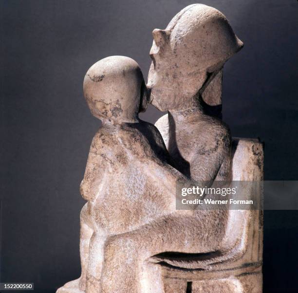 Akhenaton kisses his daughter as she sits on his lap, An unfinished statue. Egypt. Ancient Egyptian. Amarna period c 1373 1357 BC. Tell el Amarna.