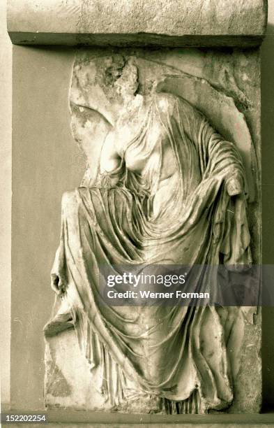 Relief of Nike fastening her sandal from the balustrade of the temple of Athena Nike , Greece. Ancient Greek. C 410 BC. Acropolis, Athens.