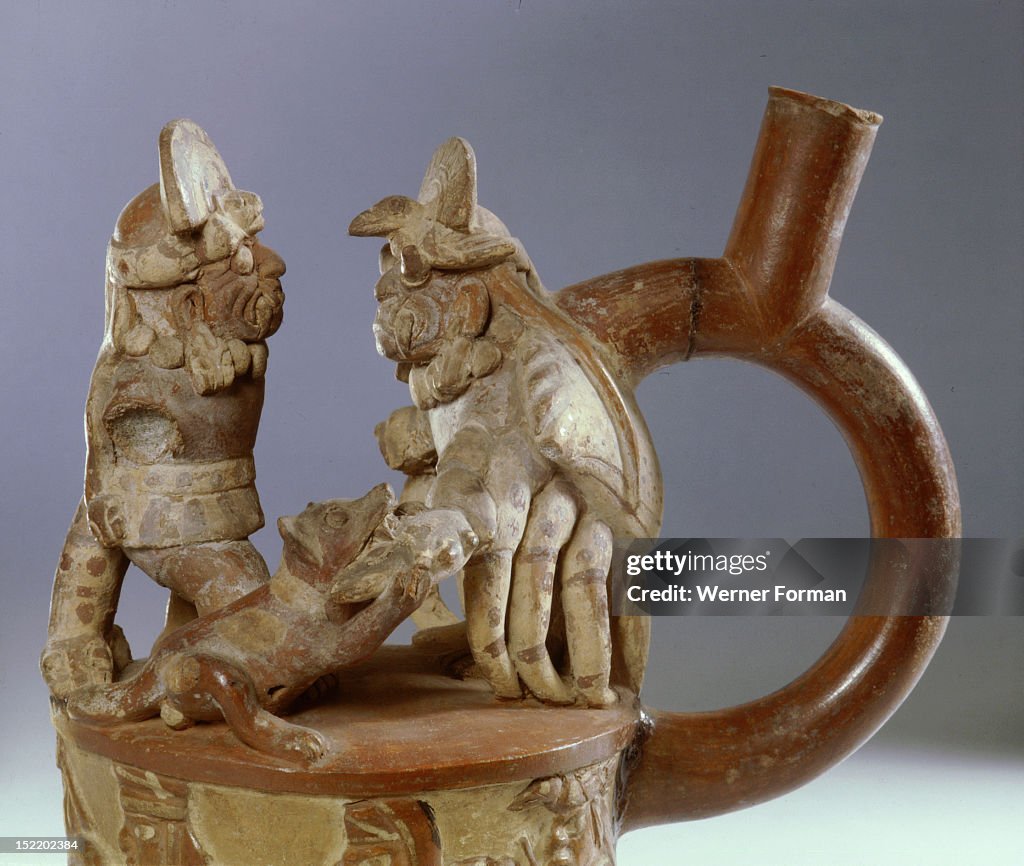 Mochica, stirrup spouted jar showing an scene from mythology in which a fanged deity accompanied by a dog confronts a crab monster
