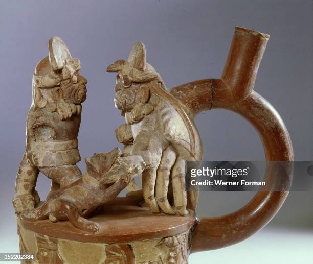 Mochica, stirrup spouted jar showing an scene from mythology in which a fanged deity accompanied by a dog confronts a crab monster, Both figures have...