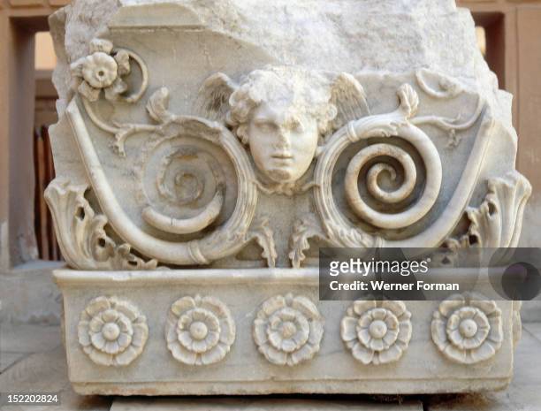 Relief carving depicting a winged head framed by plant tendrils and flowers, Egypt. Graeco Roman. Ptolemaic Period. Alexandria.