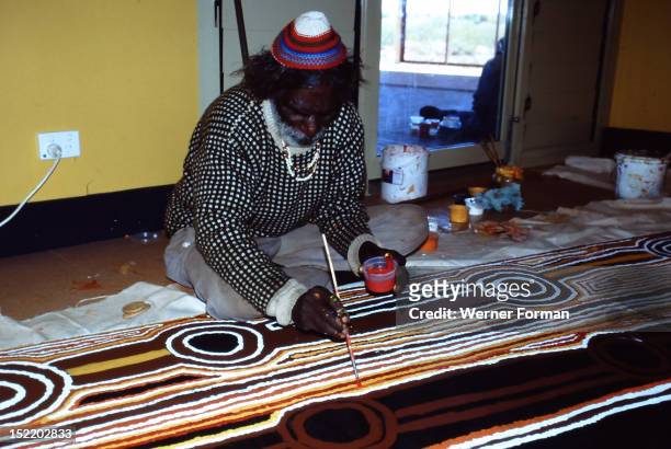 Balgo Community desert artist, the late Tjumpo Tjapanangka, working on a dot painting at the Warlayirti Culture Centre in the north-west desert...