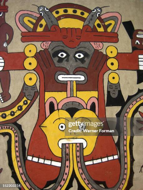 Reconstructed Nazca mural depicting an anthropomorphic mythological being, It has a golden headdress and shell earring ending in miniature trophy...