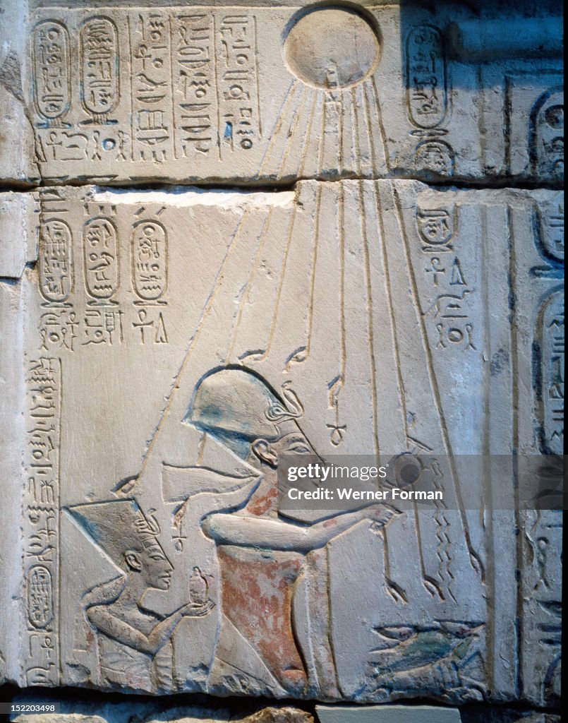 Sunk relief from the facade of a shrine showing Akhenaten and Nefertiti offering libations to Aten, the sun god