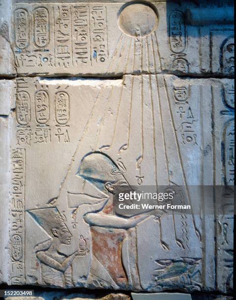 Sunk relief from the facade of a shrine showing Akhenaten and Nefertiti offering libations to Aten, the sun god, During the Amarna period shrines in...