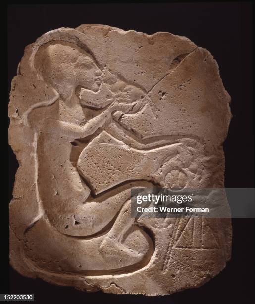 Relief fragment depicting a princess sitting on a cushion and eating, Egypt. Ancient Egyptian. 18th dynasty c 1352 1336 BC, Amarna period.