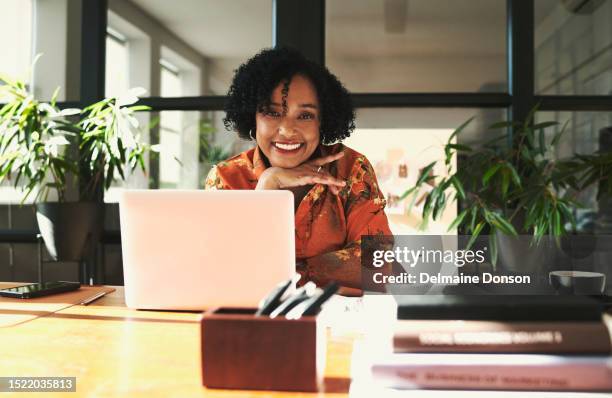 mature business woman sitting in front of her laptop computer. stock photo - person in front of computer stock pictures, royalty-free photos & images