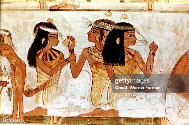 Detail of a painting from the tomb of Nakht depicting three ladies at a feast, The wear perfumed cones in their hair and elaborate necklaces. Egypt....