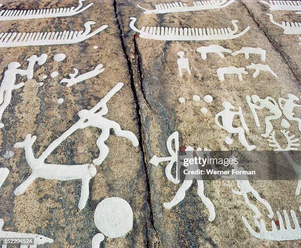Petroglyphs with human figures,apparently hunting, Ships in the background. Bronze Age Boat Axe culture Petroglyphs with human figures,apparently...