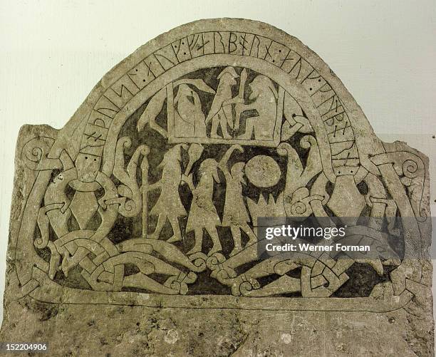Picture stone with runic writing across the top, It has been suggested that the standing figure in the house is Odin. He is with Ermaneric, the Goth...