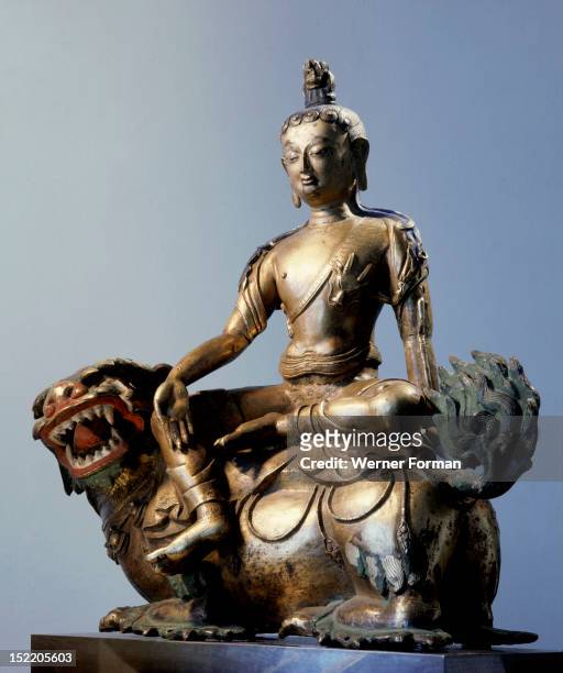 Statue of Simhanada, Voice of a Lion, sitting on the back of a roaring lion, He is a form of Avalokitesvara. Tibet. Buddhist. 17th century.