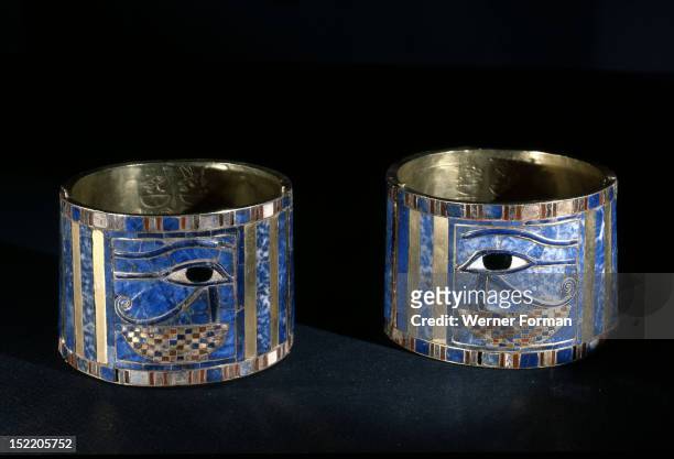 Pair of bracelets found on Shoshenq IIs body with representations of the Wedjat eye upon a basket, The eyes are depictions of the eyes of the god...