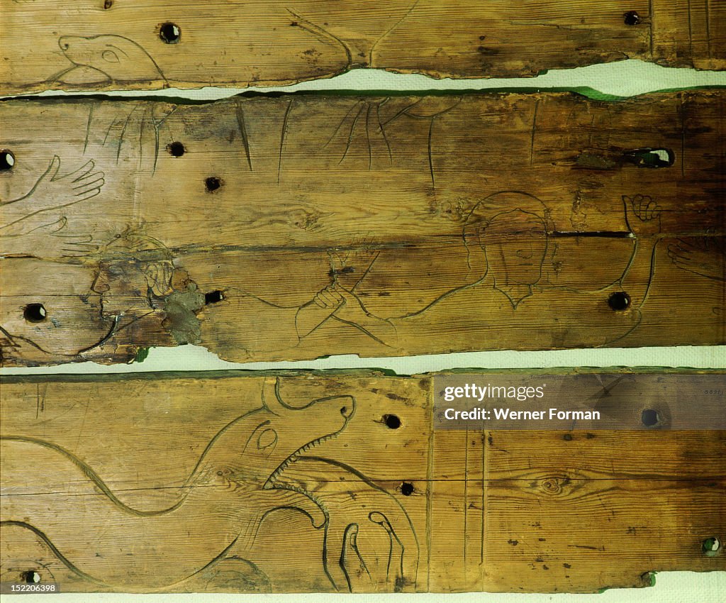 Wood panel depicting Odin being swallowed by Fenrir