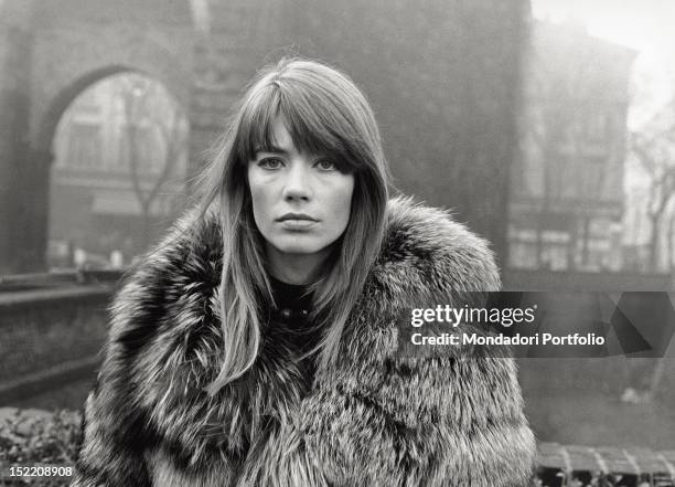 The French singer and actress Francoise Hardy wearing a fur coat in Piazza Sant'Ambrogio. Milan, 1960s