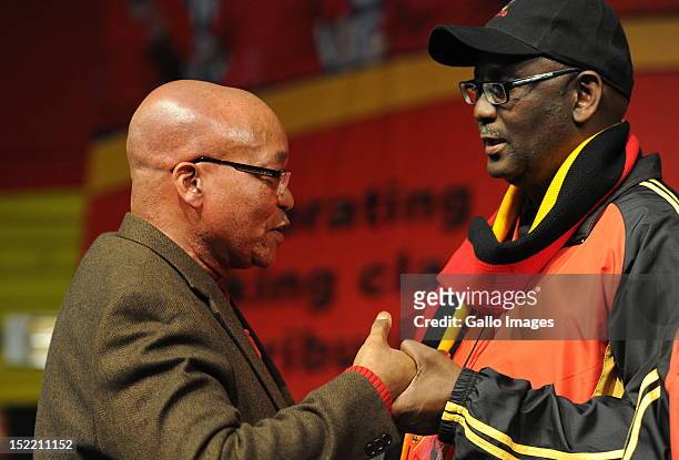 President Jacob Zuma holds hands with Cosatu General Secretary Zwelinzima Vavi during Cosatu's 11th National Conference at Gallagher Estate on...
