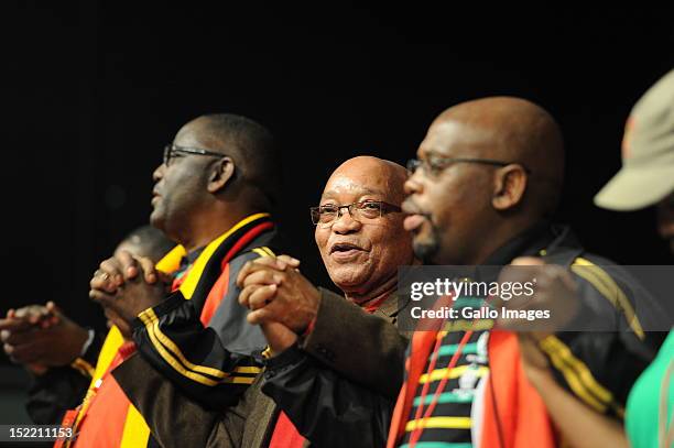 President Jacob Zuma holds hands with Cosatu General Secretary Zwelinzima Vavi and the unions President Sdumo Dlamini during Cosatu's 11th National...