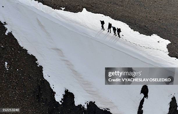 Kyrgyz mountain climbers trek to the top of the 4446m Vladimir Putin Peak in the Tian Shan mountains some 100km outside Kyrgyz capital Bishkek on...