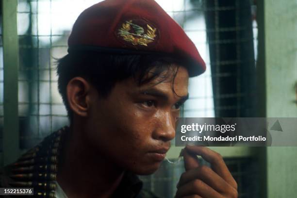 Close-up of a Vietnamese soldier from the US occupying force playing with his chewing-gum. Khe Sanh , 1968.