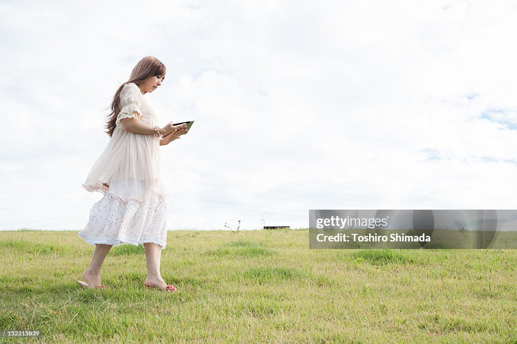 Girl walking and using tablet pc