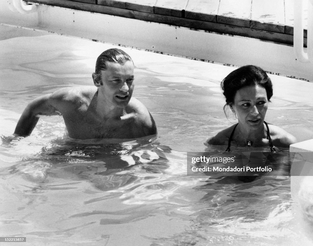 Helmut Berger and Flora Carabella in a swimming pool