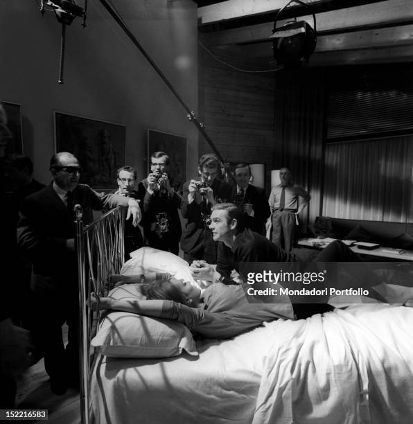 The actors Sean Connery and Luciana Paluzzi besieged by photographers during the shooting of a hot scene from the movie Thunderball, fourth episode...