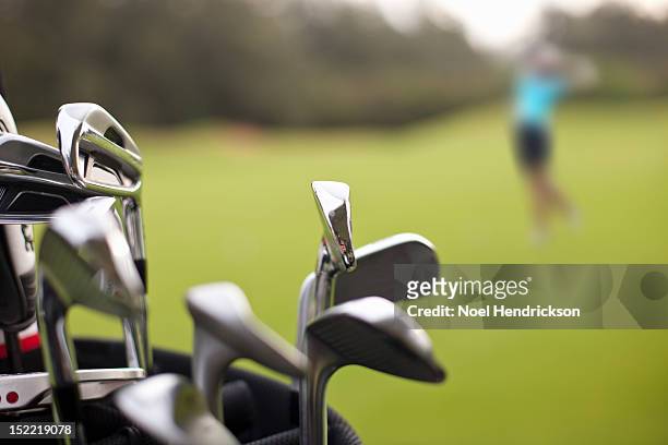 a set of golf clubs on the green - golf bag stock pictures, royalty-free photos & images
