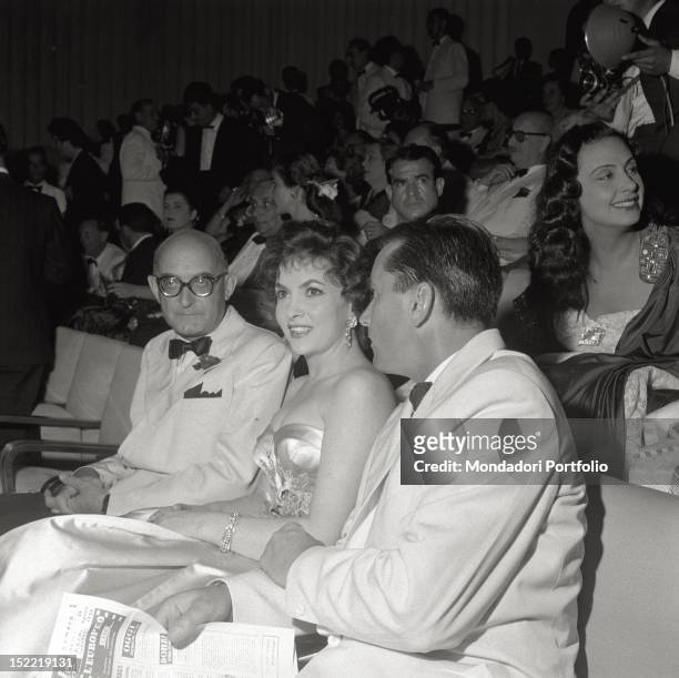 The actress Gina Lollobrigida is seated in the stalls as a guest of XVII Venice International Film Festival, next to her there is his husband Milko...