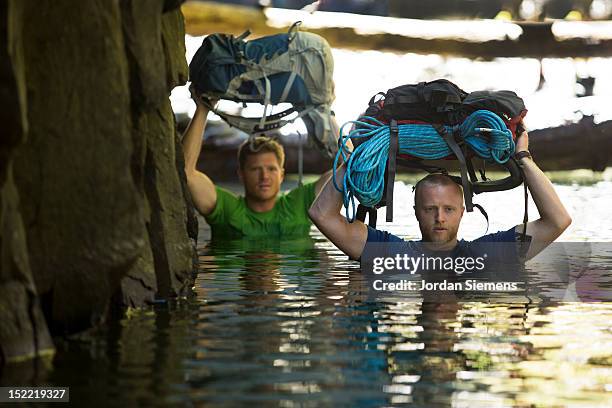 two men hiking a narrow canyon. - oneonta falls stock pictures, royalty-free photos & images