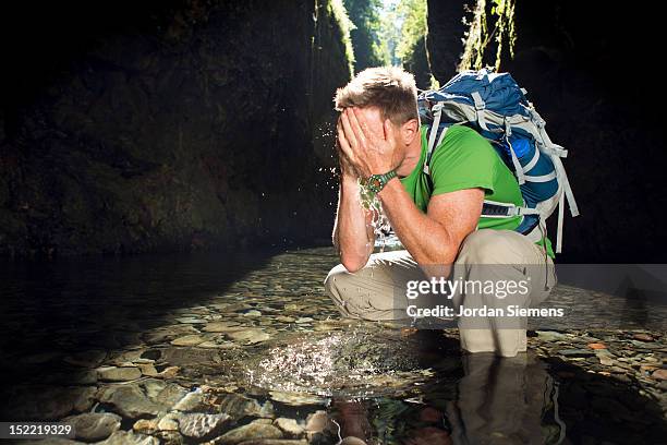 a man hiking a narrow canyon filled with water. - oneonta falls bildbanksfoton och bilder