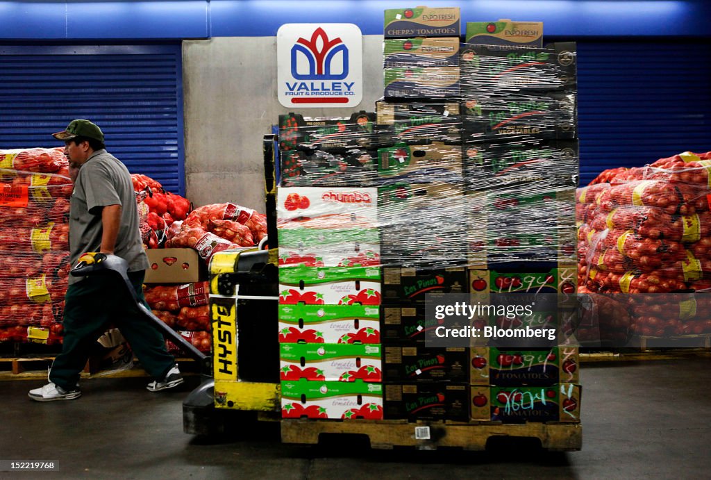 Val Procucer A worker pulls pallets of fresh produce to be loaded onto a truck at ...