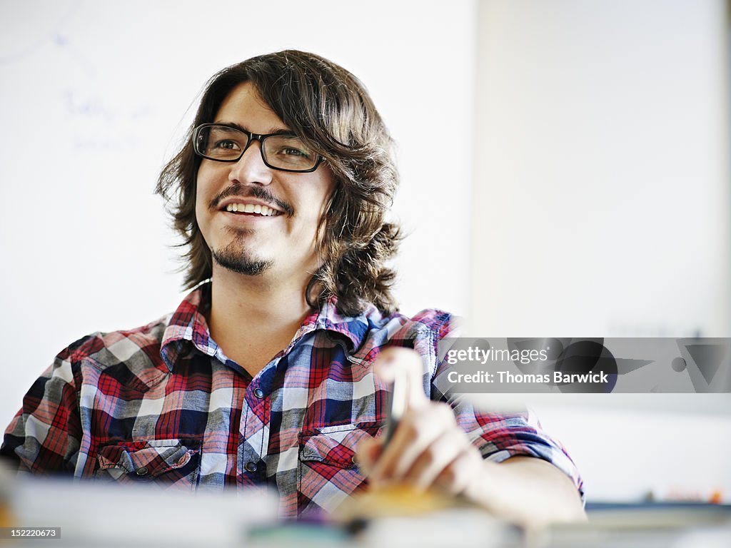 Businessman sitting in discussion at workstation