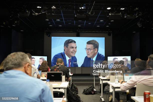 Members of the media watch Pedro Sanchez, Spains prime minister and PSOE party leader, and Alberto Nunez Feijoo, the Peoples Party leader, during a...