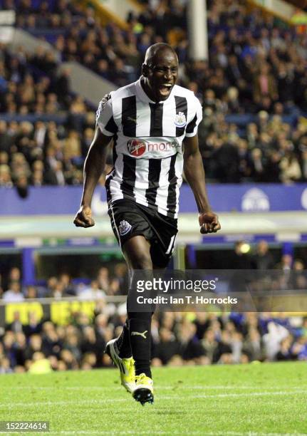 Demba Ba of Newcastle United celebrates scoring the second equalizing goal during the Barclays Premier League match between Everton and Newcastle...
