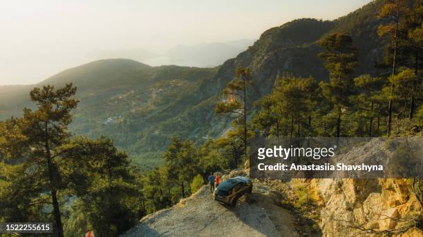 aerial view of woman and man contemplating road trip in turkey enjoying scenic views from above - ölüdeniz stock pictures, royalty-free photos & images
