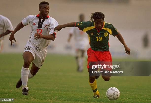 Etame Mayer of Cameroon holds off Yao Aziawonou of Togo during the African Nations Cup match at Kumas Stadium in Kumas, Ghana. Togo won the game 1-0....