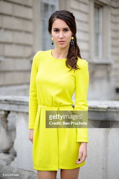 Journalism student Elle poses wearing a H+M dress and earrings and Miss Selfridge shoes at the Mark Fast fashion show during London Fashion Week S/S...