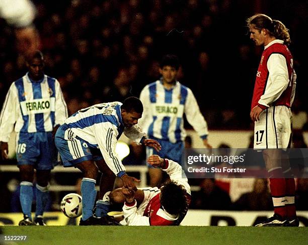 Djalminha of Deportivo La Coruna apologises to Gilles Grimandi of Arsenal during the UEFA Cup fourth round first leg game played at Highbury in...