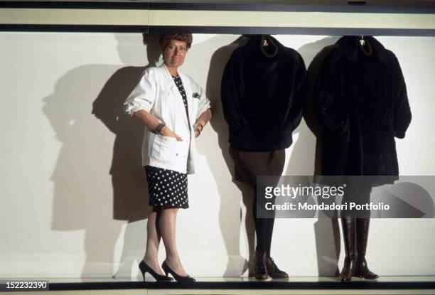The Italian business woman Carla Fendi standing near some models made by her fashion house. 1987