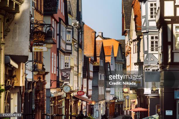 medieval city centre with half-timbered architecture in marburg, germany - marburg germany stock pictures, royalty-free photos & images