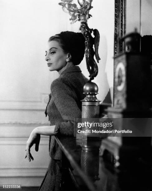 French actress and model Capucine posing in a hotel wearing a Chanel dress. Rome, 1962