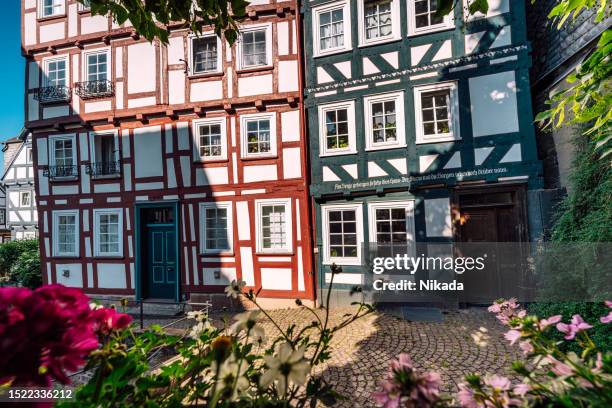 city steet with half-timbered architecture in marburg, germany - hesse imagens e fotografias de stock