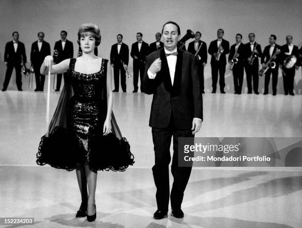 The Italian conductor and composer Gorni Kramer hosting with the Italian actress Lauretta Masiero the TV show 'Alta Fedeltà'. January 1962