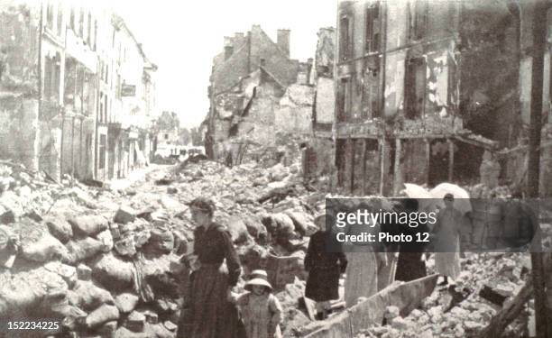France World War I, Liberation of Chateau-Thierry, In the streets blocked with rubble and cut by barricades, women and children who had remained in...