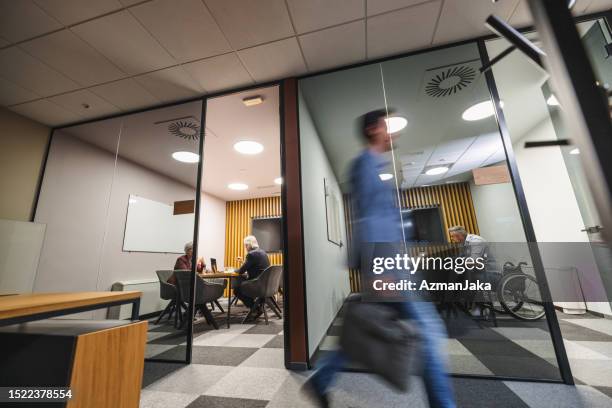 office employees working at night in a public institution - bank of slovenia stock pictures, royalty-free photos & images