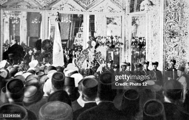 Iran Celebration for the coronation of new Shah of Persia, Shah Reza Khan Pahlevi, with the crown on his head, is seated on the 'Peacocks' throne, in...