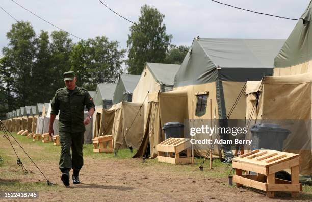 Belarusian soldier walks through a newly-built camp on a site previously used by the Belarusian army that could potentially accommodate up to 5,000...