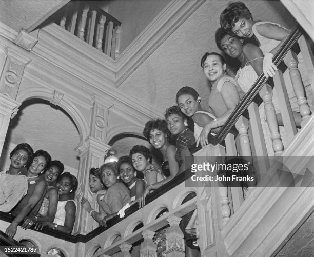 Carnival Queen contestants looking over a balustrade at the West Indian Students Hostel, Earl's Court, London, January 11th 1959. Preparations were...