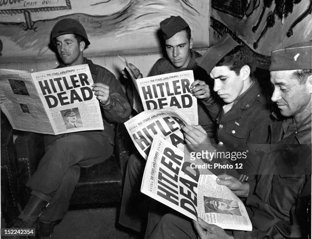 Combat soldiers, on pass in Paris , read of the death of Adolf Hitler in an 'Extra' edition of Stars and Stripes .