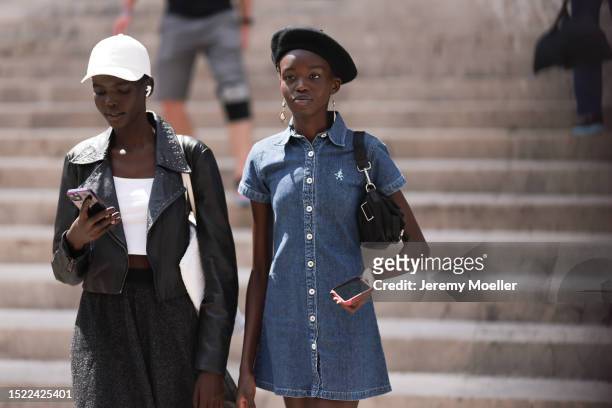 Fashion Week guest is seen wearing a white cap, a black leather jacket, underneath a white top, a fluttering skirt and white sneakers. The guest...