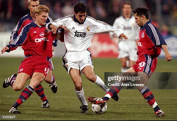 Raul of Real Madrid is challenged by Steffan Effenberg and Nils Eric Johansson of Bayern Munich during the UEFA Champions League game between Bayern...